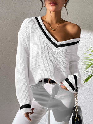 White ribbed knit sweater with varsity stripe V-neck and cuffs, styled off-shoulder.