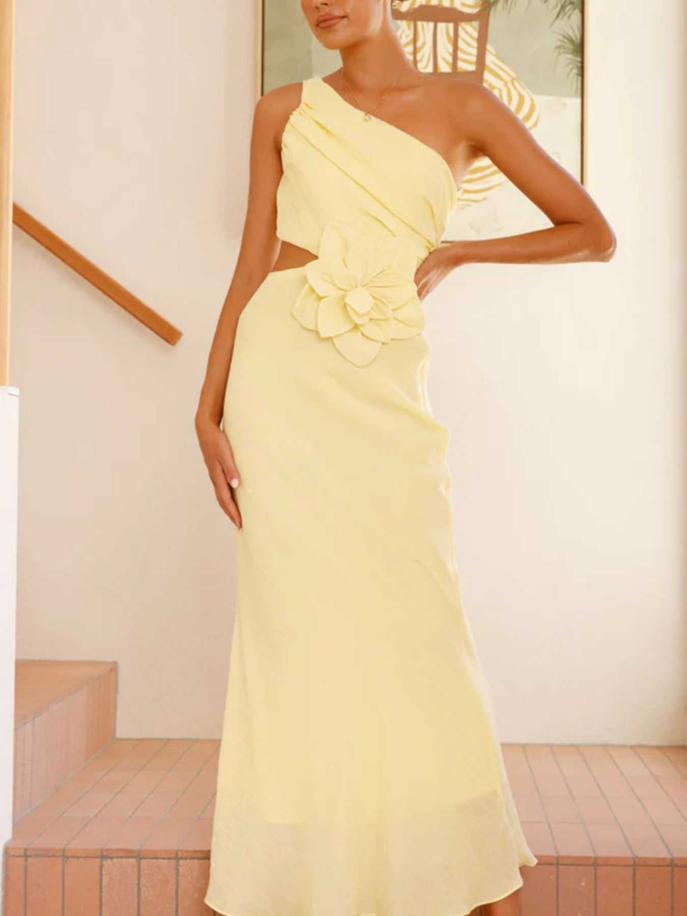 Yellow one-shoulder maxi dress with floral appliqué and cutout detail.