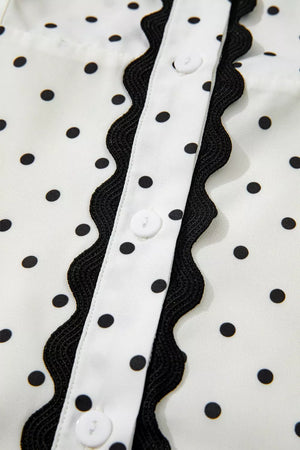 White polka dot midi dress with black scalloped trim and buttons