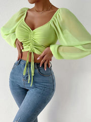 Lime ruched bodice puff sleeve crop top with drawstring detail and sheer sleeves.
