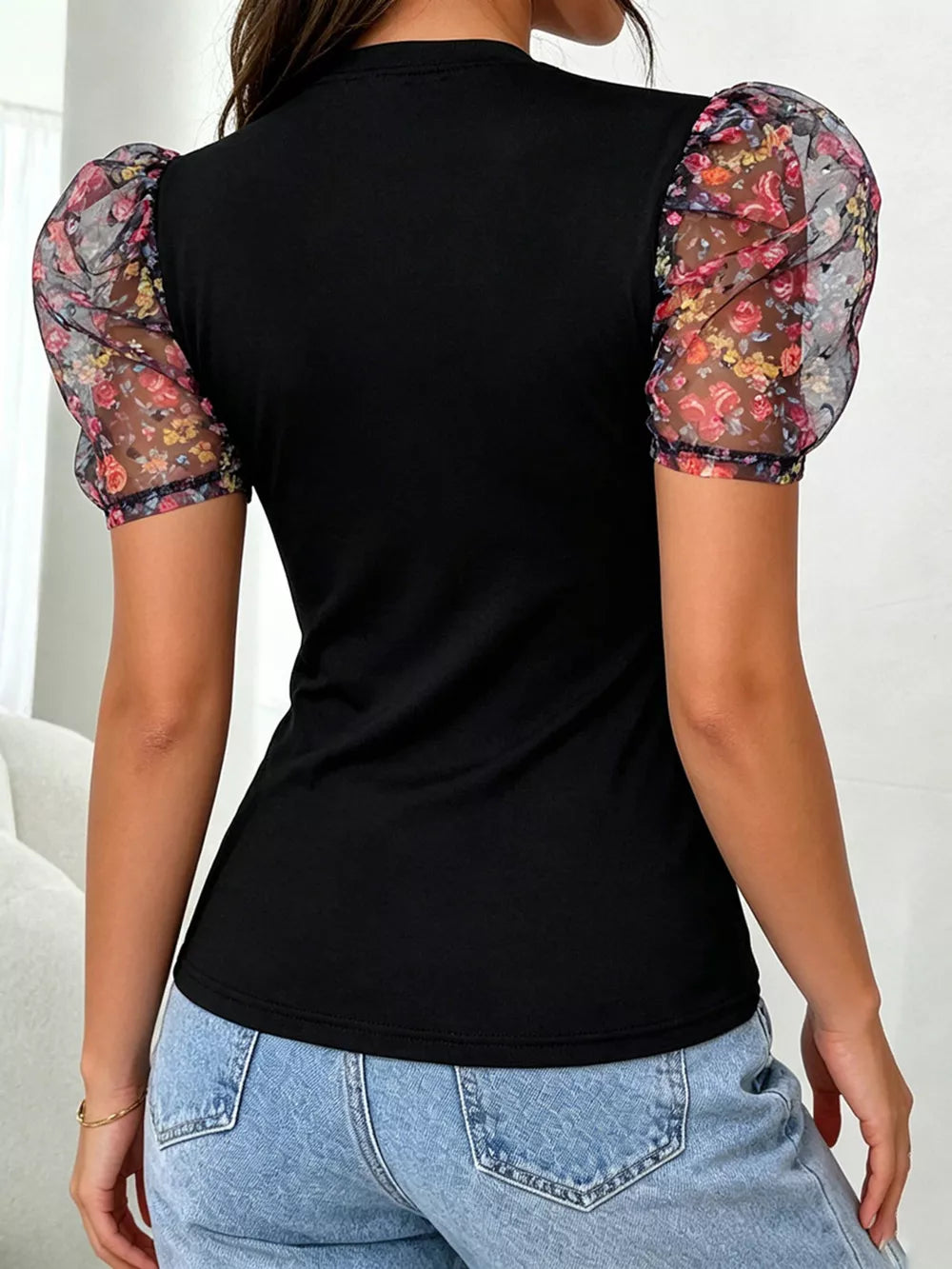 Black blouse with floral puff sleeves and mock neck
