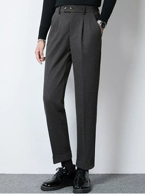 Men's dark gray pleated dress pants with cuffed hems and a double button closure.
