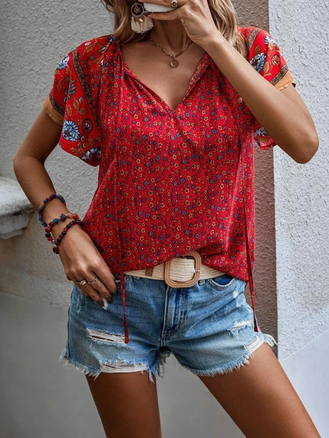 Red bohemian floral print blouse with flutter sleeves and tie neck