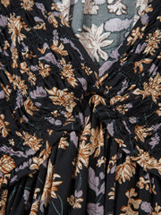 Floral babydoll dress with deep V-neck and smocked bodice detail.