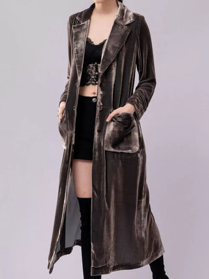Longline velvet trench coat in taupe with button closure and flap pockets.