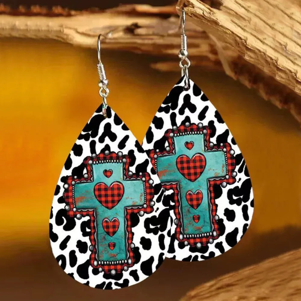 Cowhide print teardrop earrings with turquoise cross and red buffalo plaid hearts.