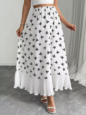 White maxi skirt with black bow print and pleated hem