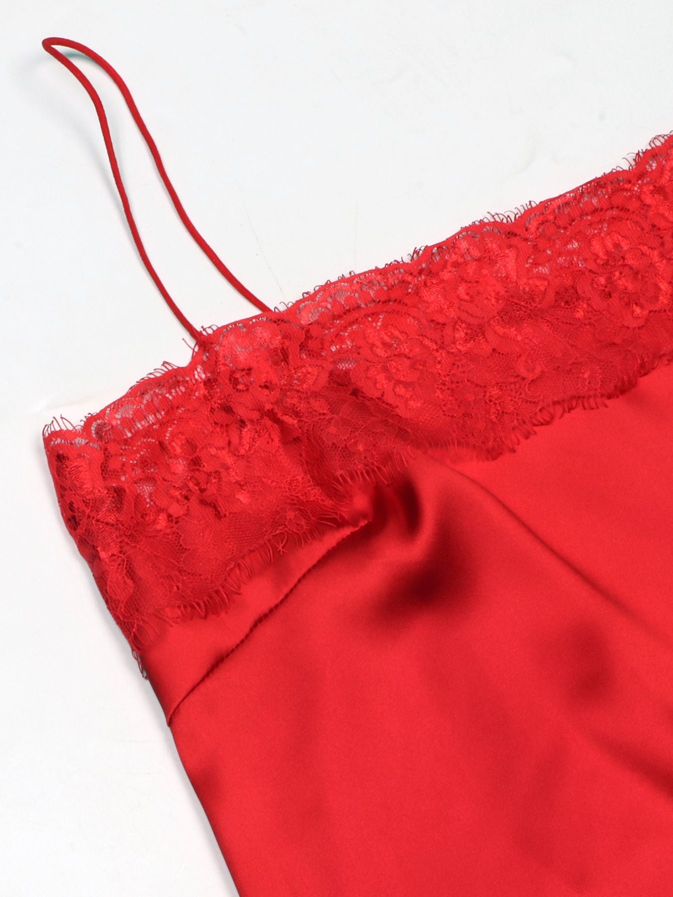 Red satin cami top with lace trim and spaghetti straps.