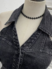 Gathered denim halter top in black with collar and button detail.
