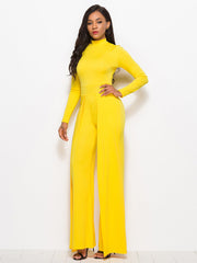 Yellow high-waisted palazzo jumpsuit with slit front and long sleeves.