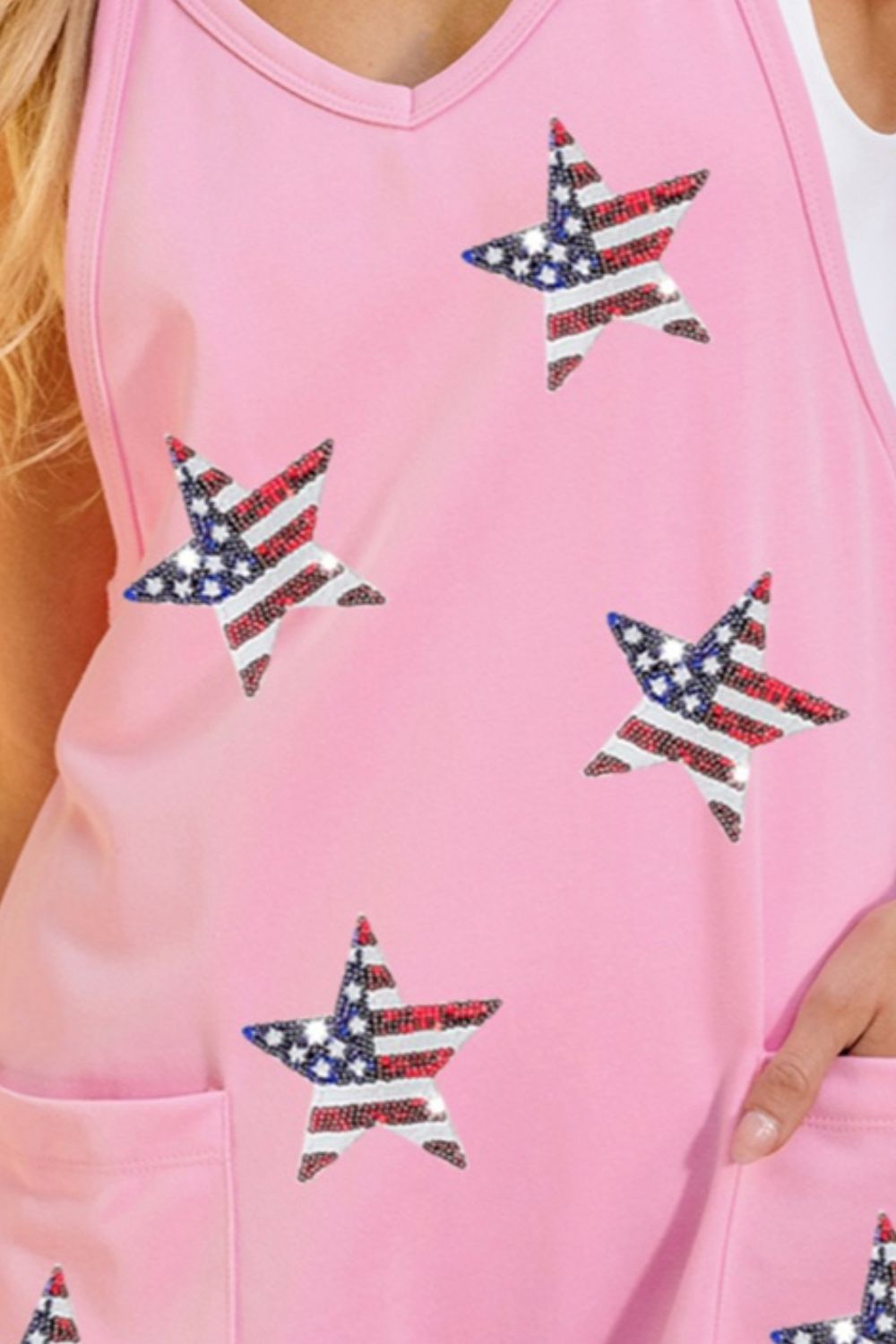 Blush pink romper with American flag star embellishments and pockets.