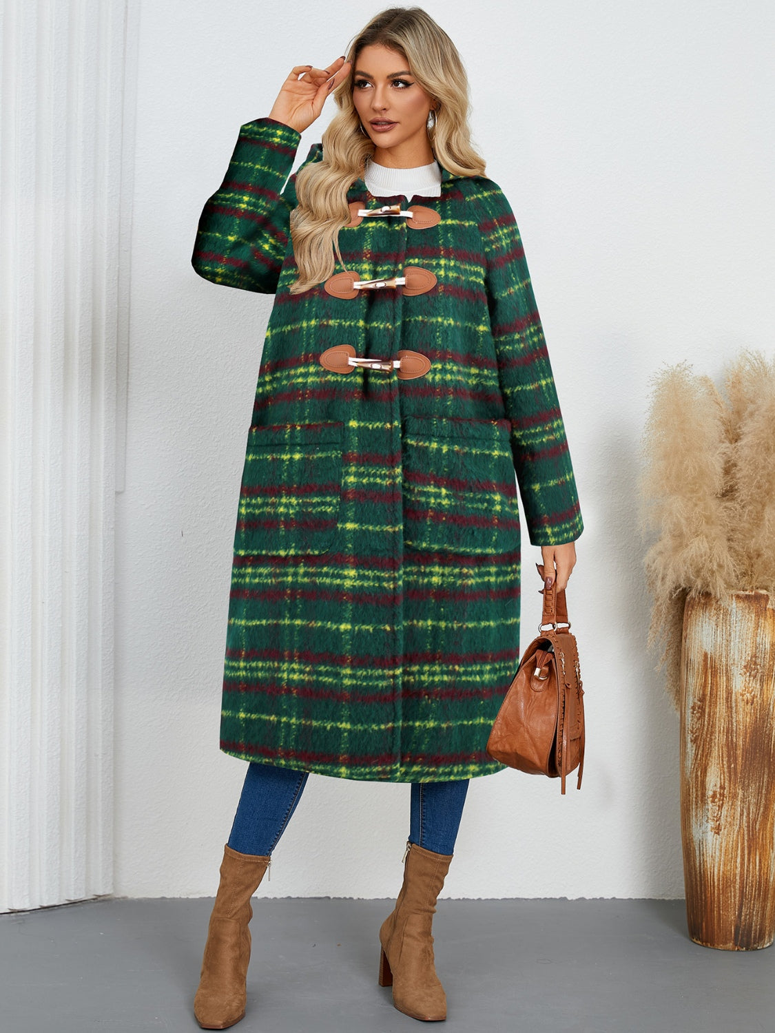Tartan toggle hooded coat in dark green with brown leather toggles and pockets.