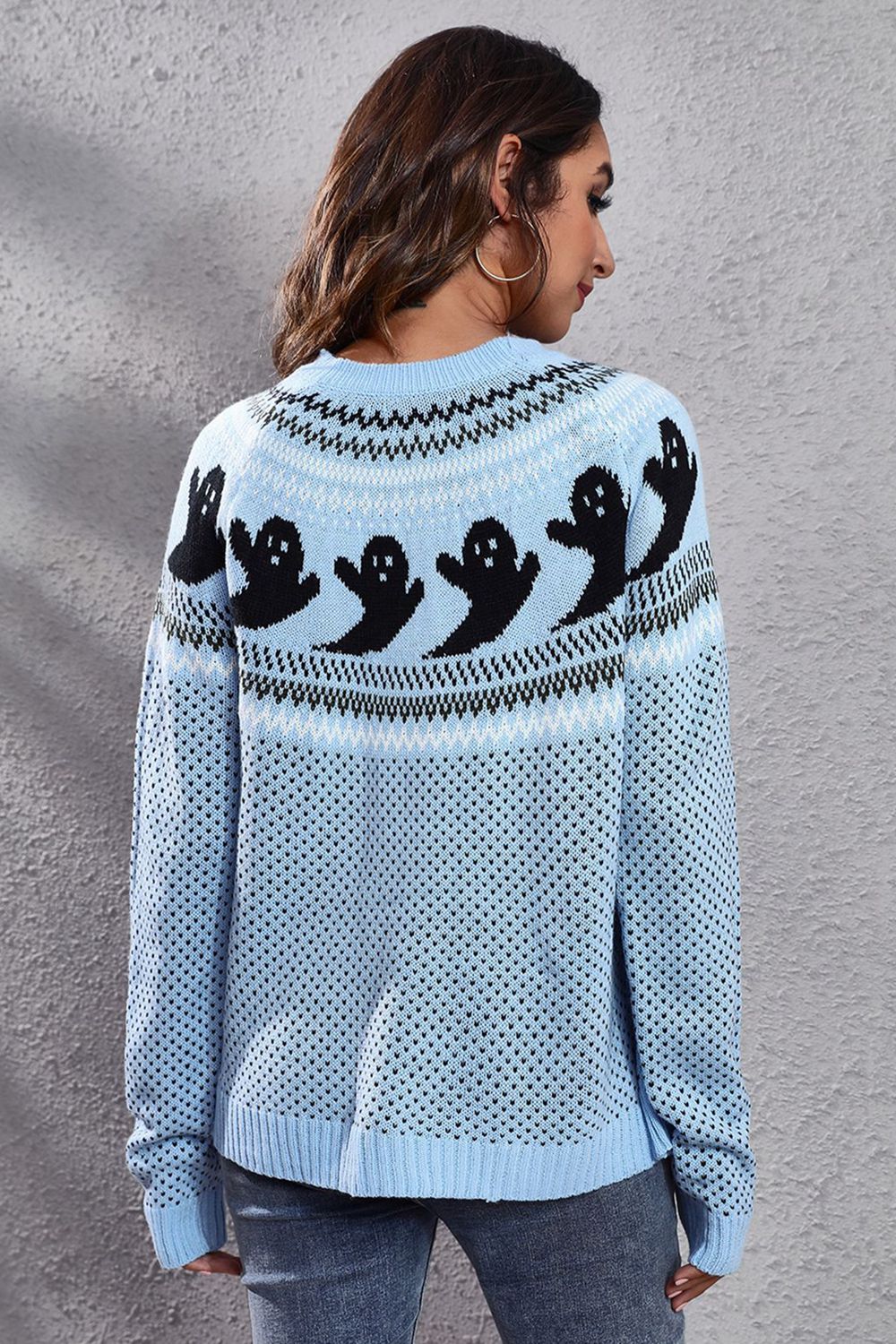 Pastel blue crewneck sweater with black ghost jacquard pattern and fair isle details.