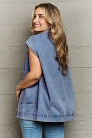 Light wash denim utility vest with oversized pockets and collared neckline.
