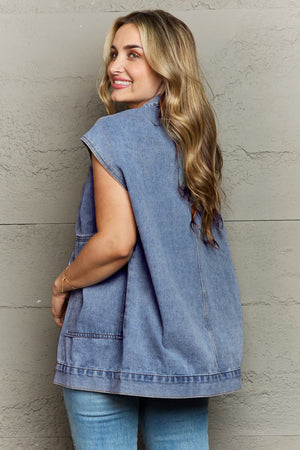 Light wash denim utility vest with oversized pockets and collared neckline.