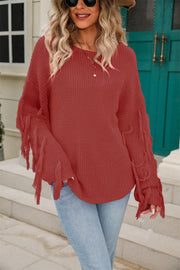 Rust acrylic knit sweater with fringe sleeves and a round neckline.