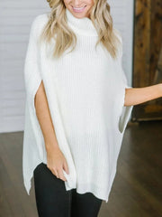 White acrylic turtleneck sweater with cape sleeves and a relaxed fit.
