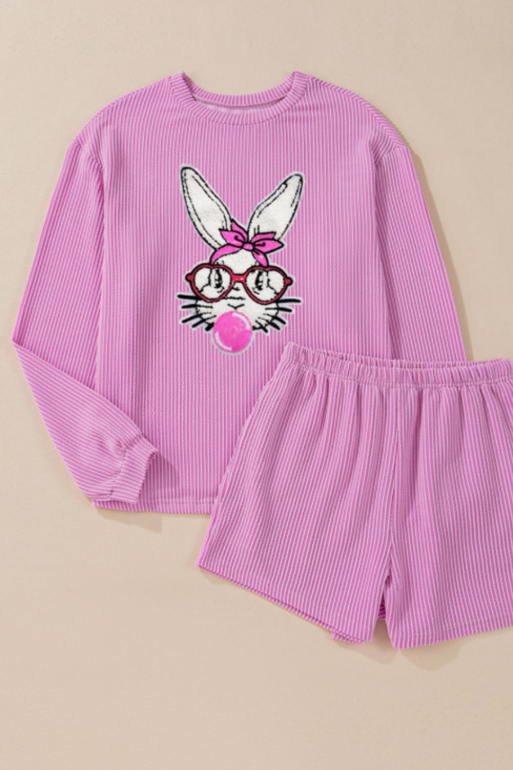 Ribbed lounge set in fuchsia pink with a graphic bunny wearing glasses and blowing bubblegum.