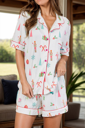 White cotton pajama set with festive holiday print and contrast piping