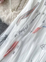 White tulle skirt with abstract sunburst print and text details.