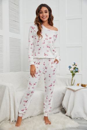 Flamingo print off-shoulder lounge set in white with long sleeves and cuffed pants.