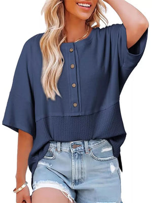 Blue waffle-knit t-shirt with button detail and textured hem.