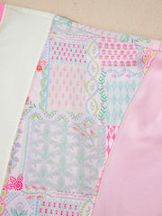 Maternity t-shirt with patchwork floral print, crew neck, and pink accent panels.