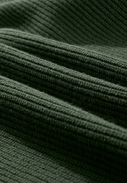 Dark green ribbed knit sweater fabric detail