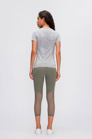 Gray activewear tee with seamless texture detail and short sleeves.