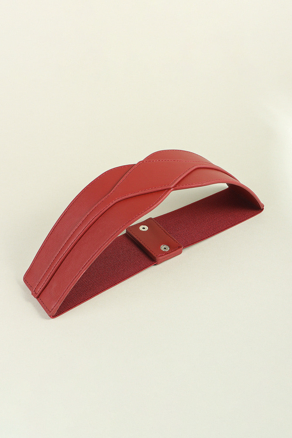 Burgundy elastic belt with sculpted faux leather front and snap closure