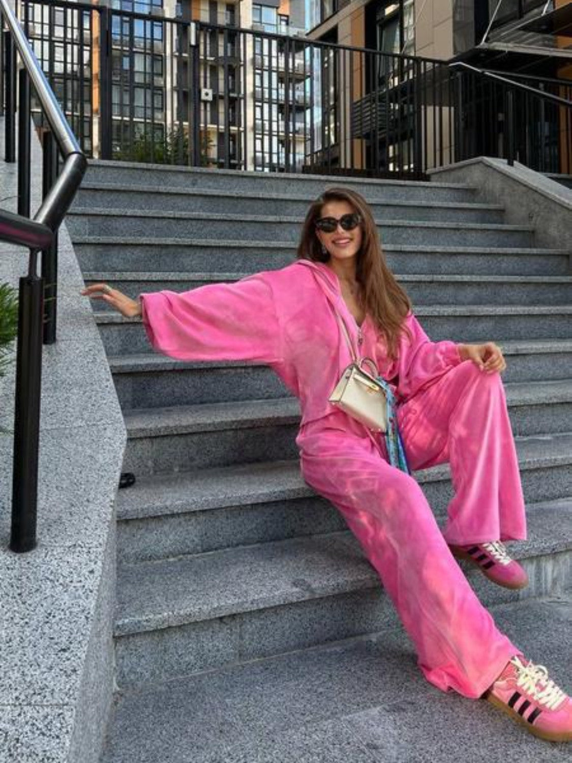 Plush velour loungewear set in hot pink with wide leg pants and a hooded zip-up jacket.