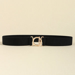 Black elasticated belt with a gold circle buckle and gold hardware