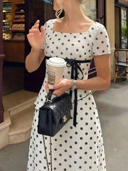 Polka dot square neck top and skirt set with black ribbon detail.