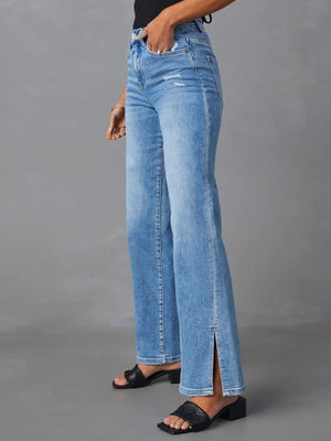 Medium wash flare jeans with distressed details and side leg slits.