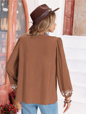 Camel embroidered yoke blouse with gathered bodice and long sleeves.