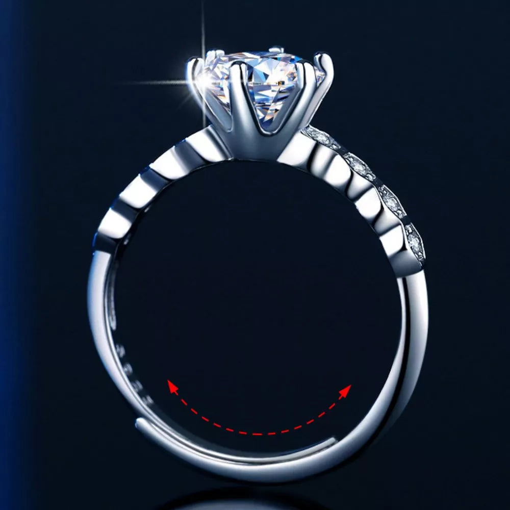 Radiant moissanite silver ring with a solitaire diamond and accent stones on the band.
