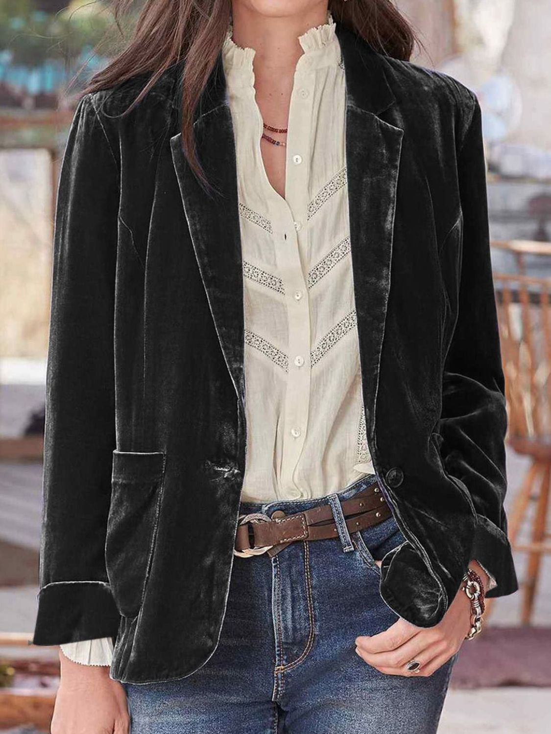 Black velvet blazer with rolled cuff detail and buttoned front, styled with a cream lace-trimmed blouse.