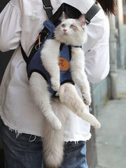 Denim-like pet carrier backpack with adjustable straps, holding a white cat.
