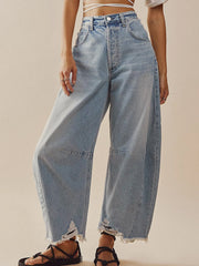 Light wash palazzo jeans with frayed hem and distressed details.