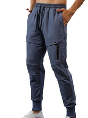 Gray technical joggers with zip pocket detail and elastic cuffs.