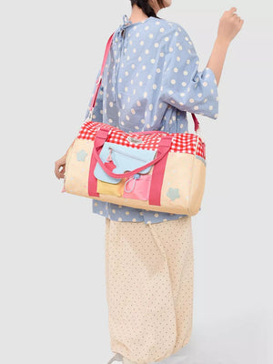 Charming gingham duffel bag with pockets, stars, and colorful accents.