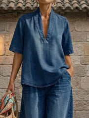 Blue denim V-neck top with short sleeves and wide-leg pants with curved hem.