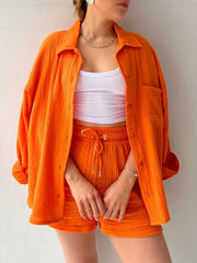 Orange textured gauze shirt and shorts set with drawstring waist and button front.