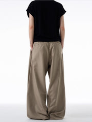 Men's khaki relaxed fit sweatpants with elastic waistband shown from back