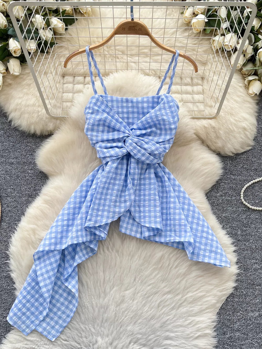 Blue gingham cami top with twisted knot detail and asymmetrical hem.