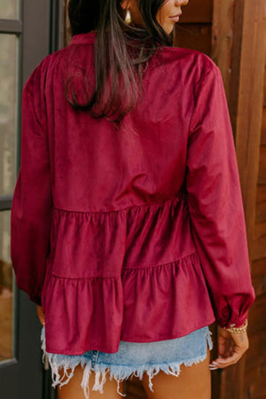 Burgundy corduroy tiered blouse with long sleeves and button details.