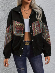 Black corduroy bomber jacket with colorful geometric patchwork on sleeves and chest.