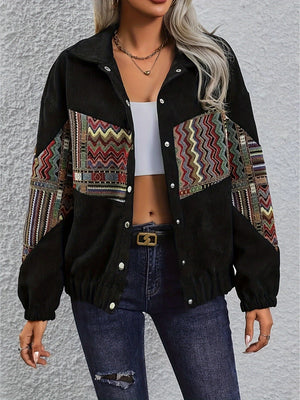 Black corduroy bomber jacket with colorful geometric patchwork on sleeves and chest.