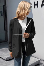 Black hooded rain jacket with white trim and drawstring waist detail.