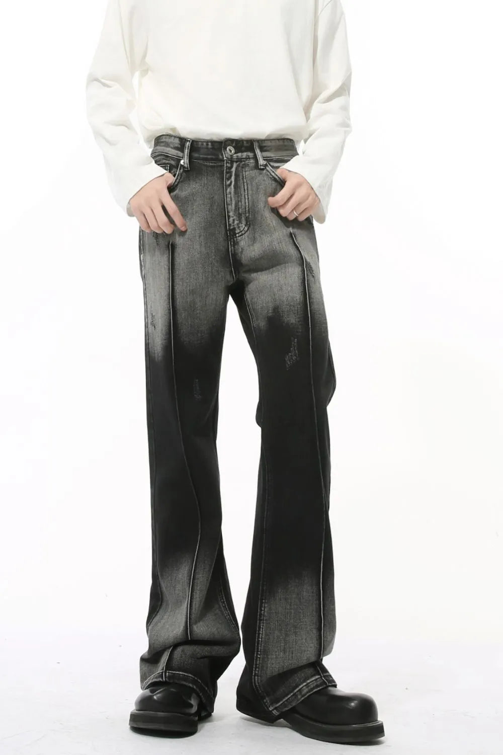 Faded flare denim jeans in dark with front pleat detail and distressed accents.